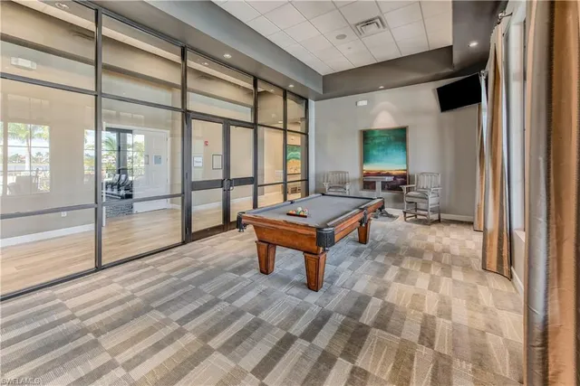 a living room with furniture a rug and a large window