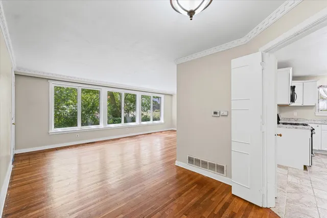 a view of wooden floor and windows in a room