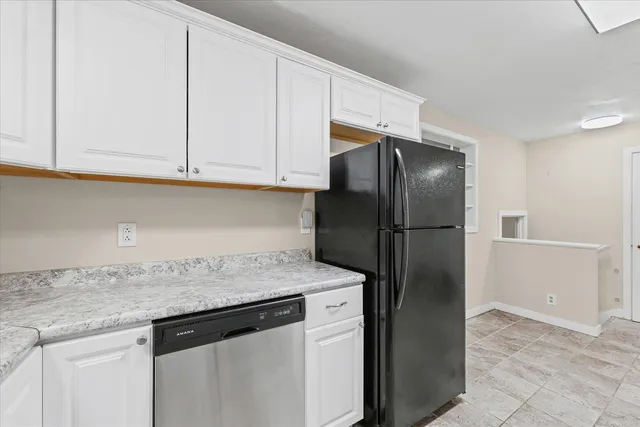 a kitchen with a refrigerator and cabinets