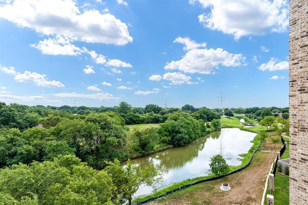 770 North Plano Road, Unit 303 Richardson, TX 75081 - Photo 25 of 26 Lush green landscape with a winding body of water, offering scenic views under a bright blue sky with white clouds