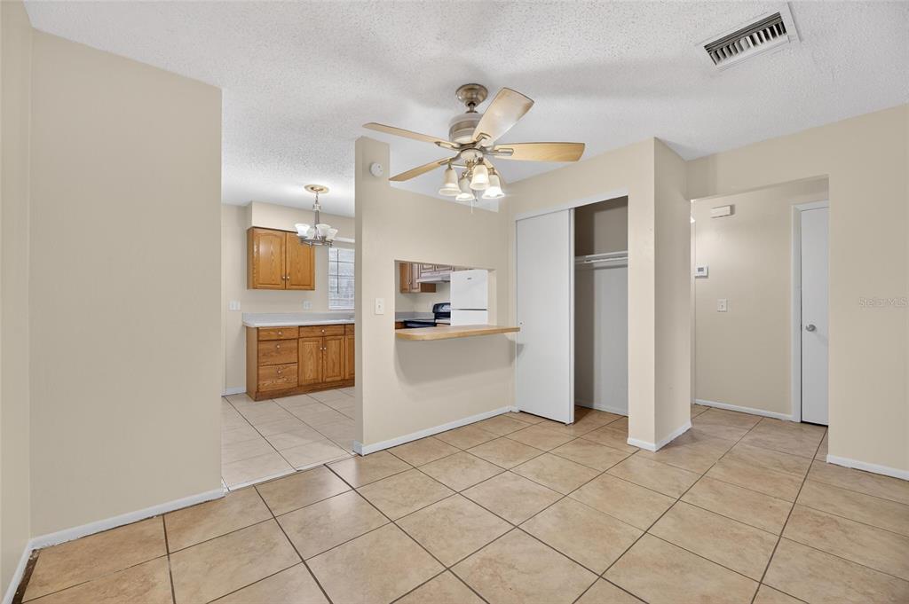 3753 141st Place North Largo, FL 33771 - Photo 19 of 44 a view of a kitchen with wooden cabinet and a ceiling fan