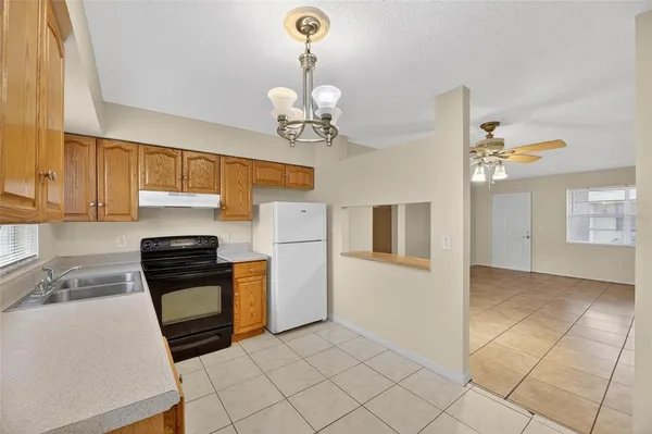 a kitchen with a sink cabinets and window