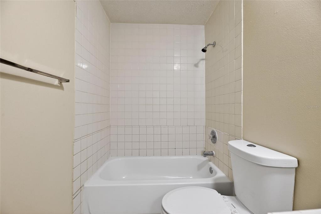 3753 141st Place North Largo, FL 33771 - Photo 33 of 44 a bathroom with a toilet and bathtub