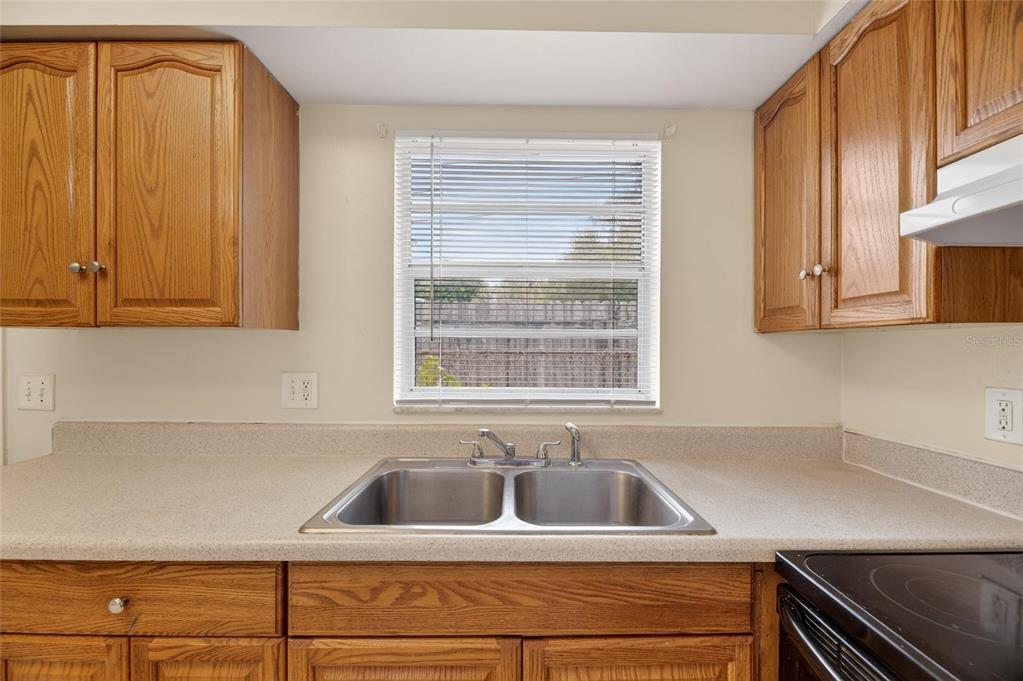 3753 141st Place North Largo, FL 33771 - Photo 42 of 44 a kitchen with a sink cabinets and window