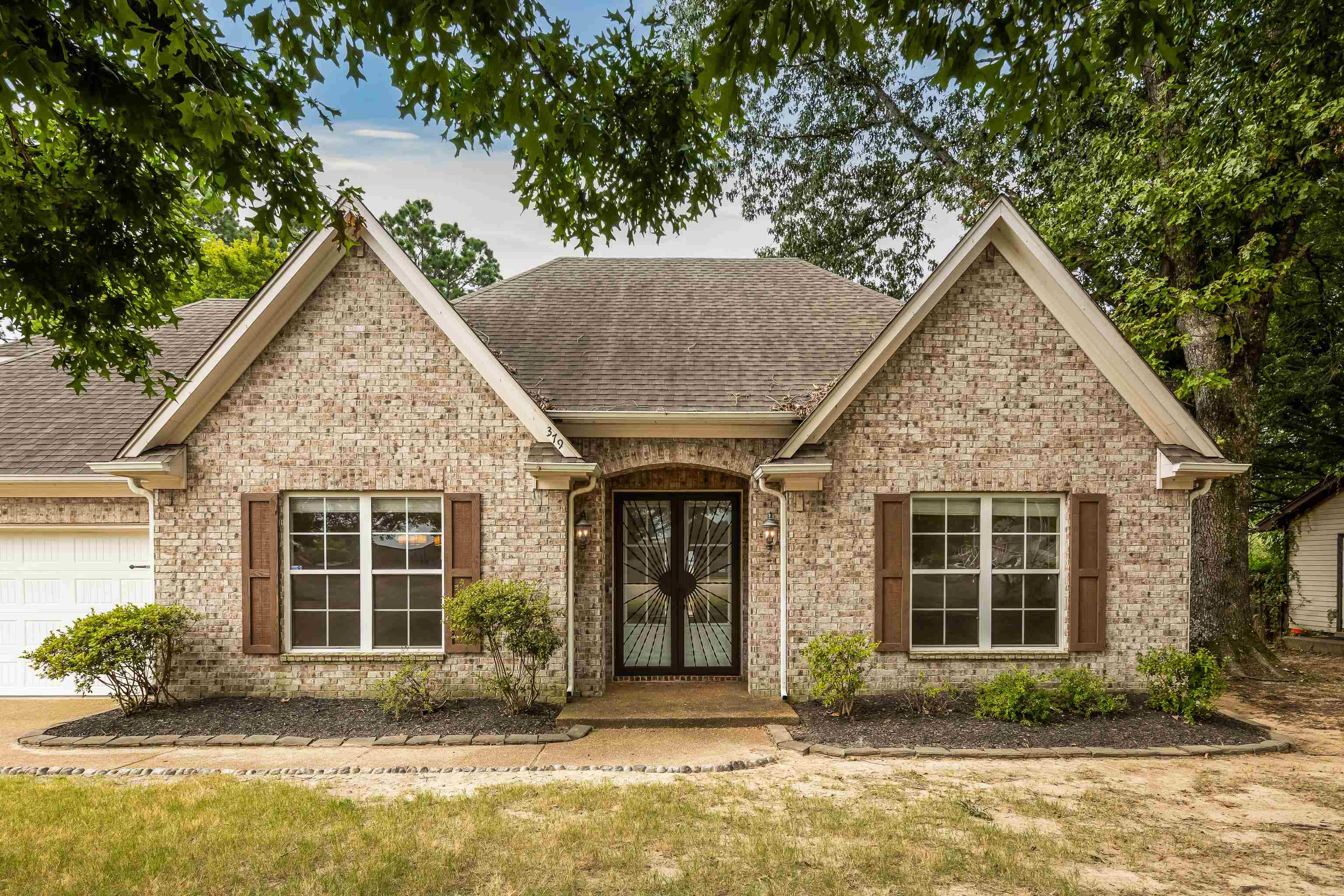a front view of a house with garden