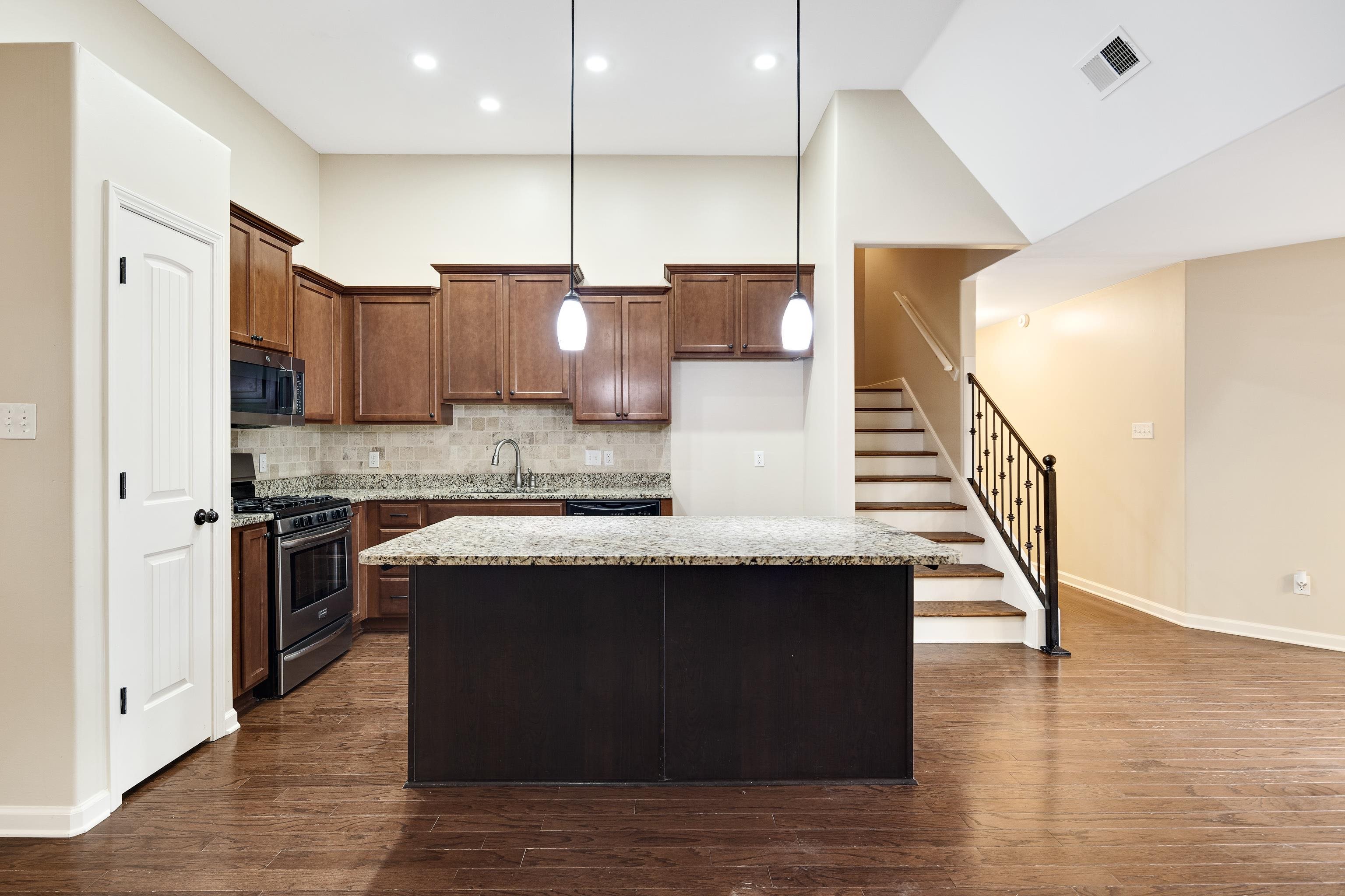 379 Shelton Road Collierville, TN 38017 - Photo 12 of 32 a kitchen with a sink cabinets and wooden floor