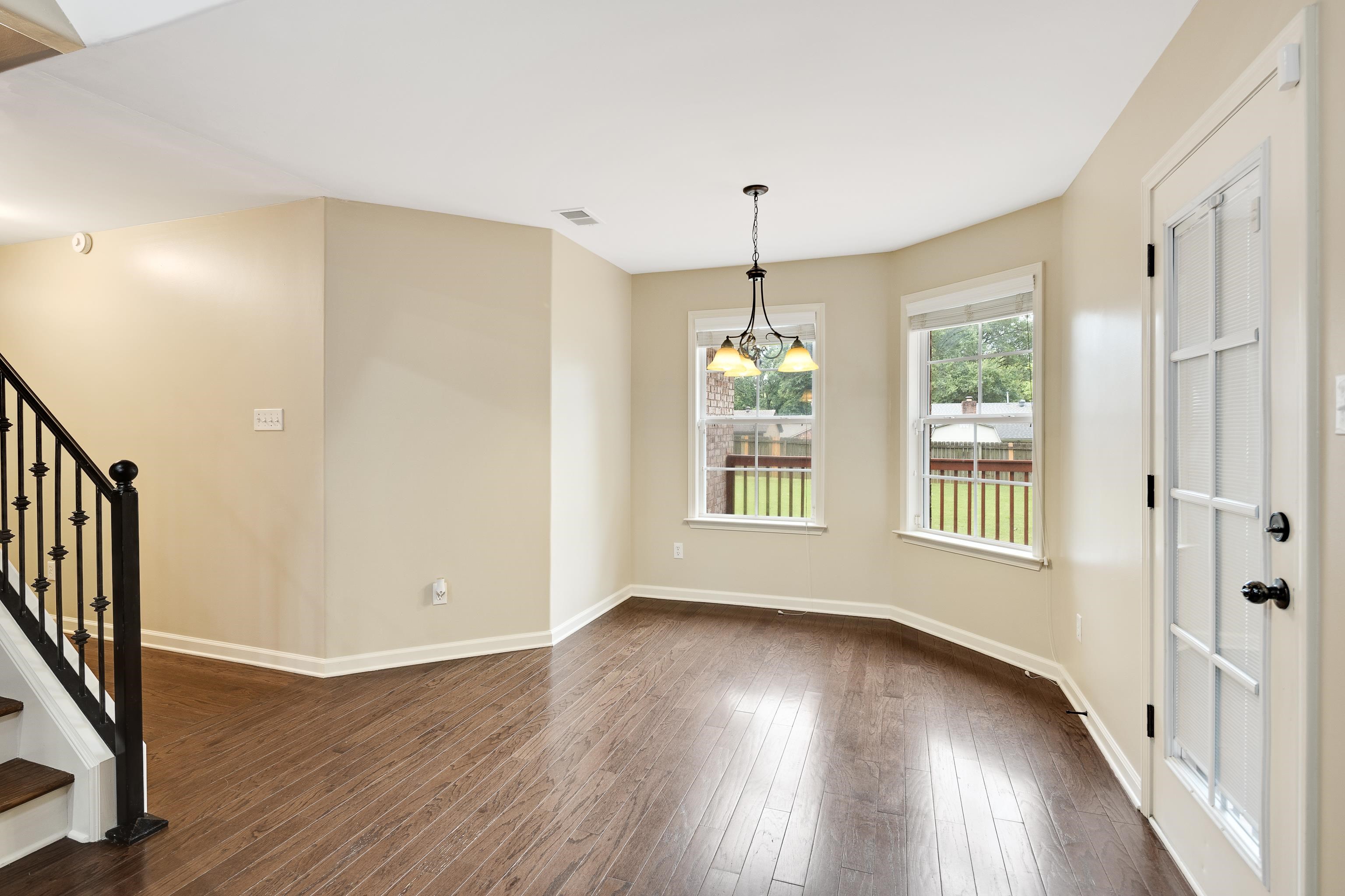 379 Shelton Road Collierville, TN 38017 - Photo 14 of 32 an empty room with wooden floor and windows