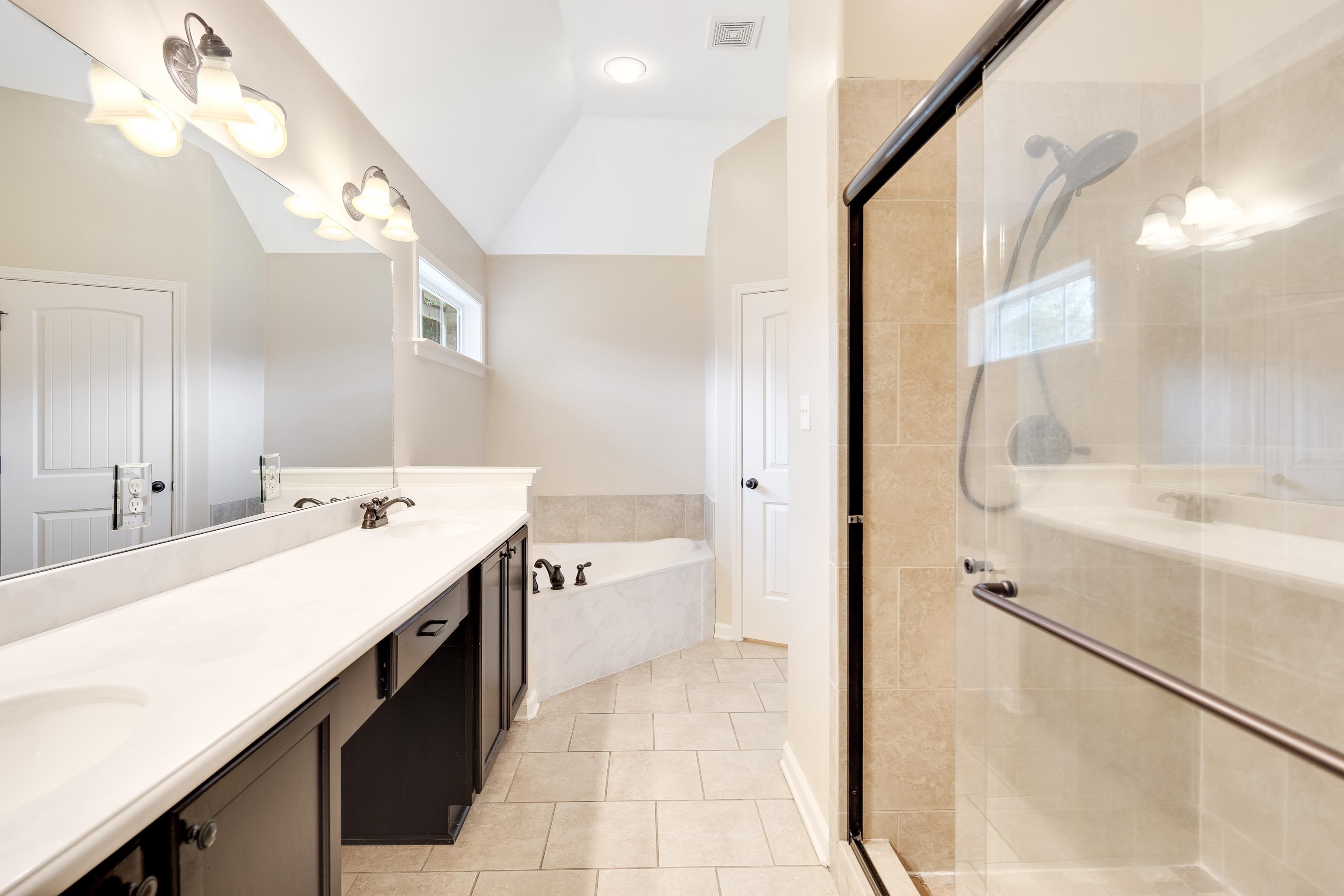 379 Shelton Road Collierville, TN 38017 - Photo 17 of 32 a bathroom with a double vanity sink mirror and shower