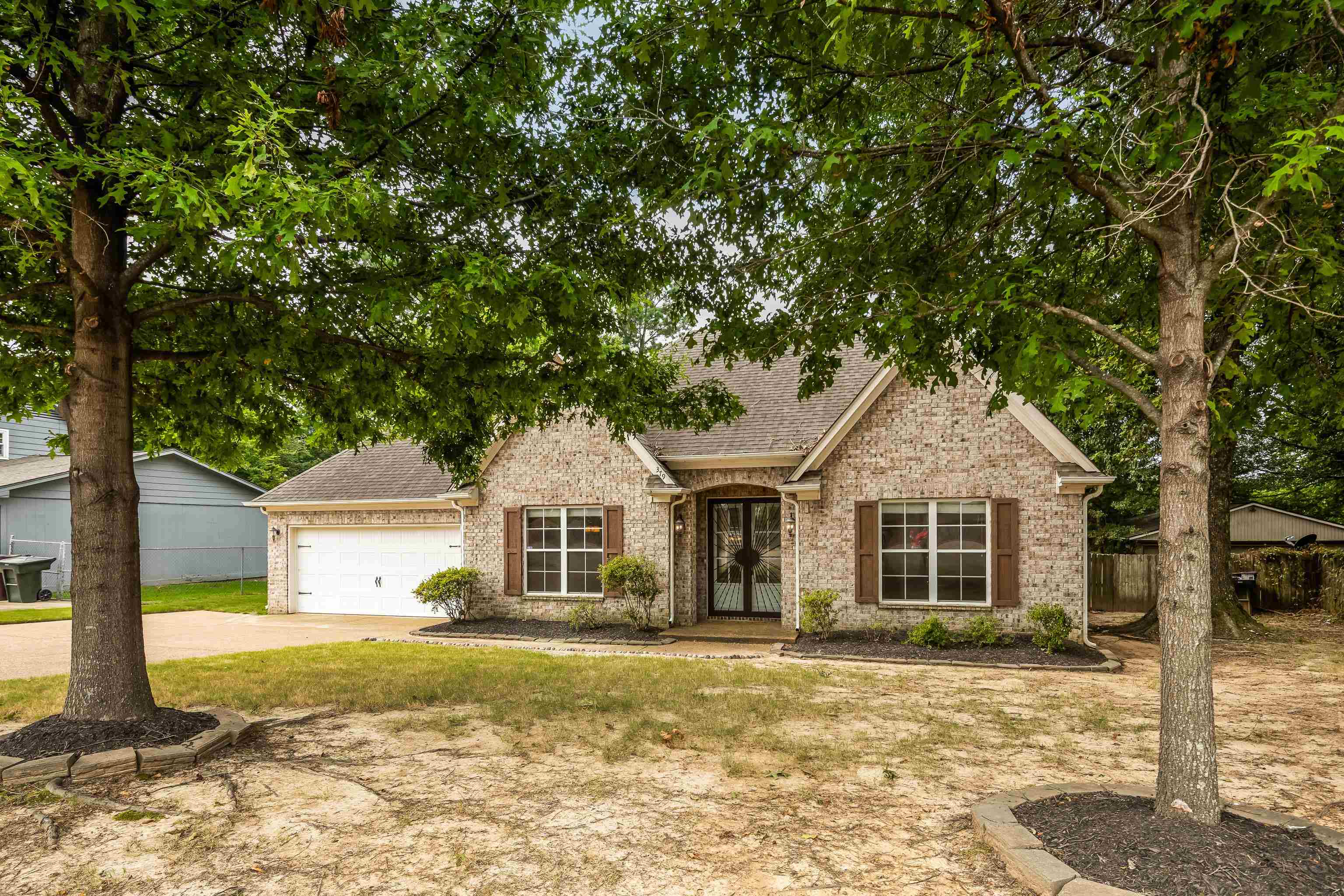379 Shelton Road Collierville, TN 38017 - Photo 2 of 32 a front view of a house with a yard