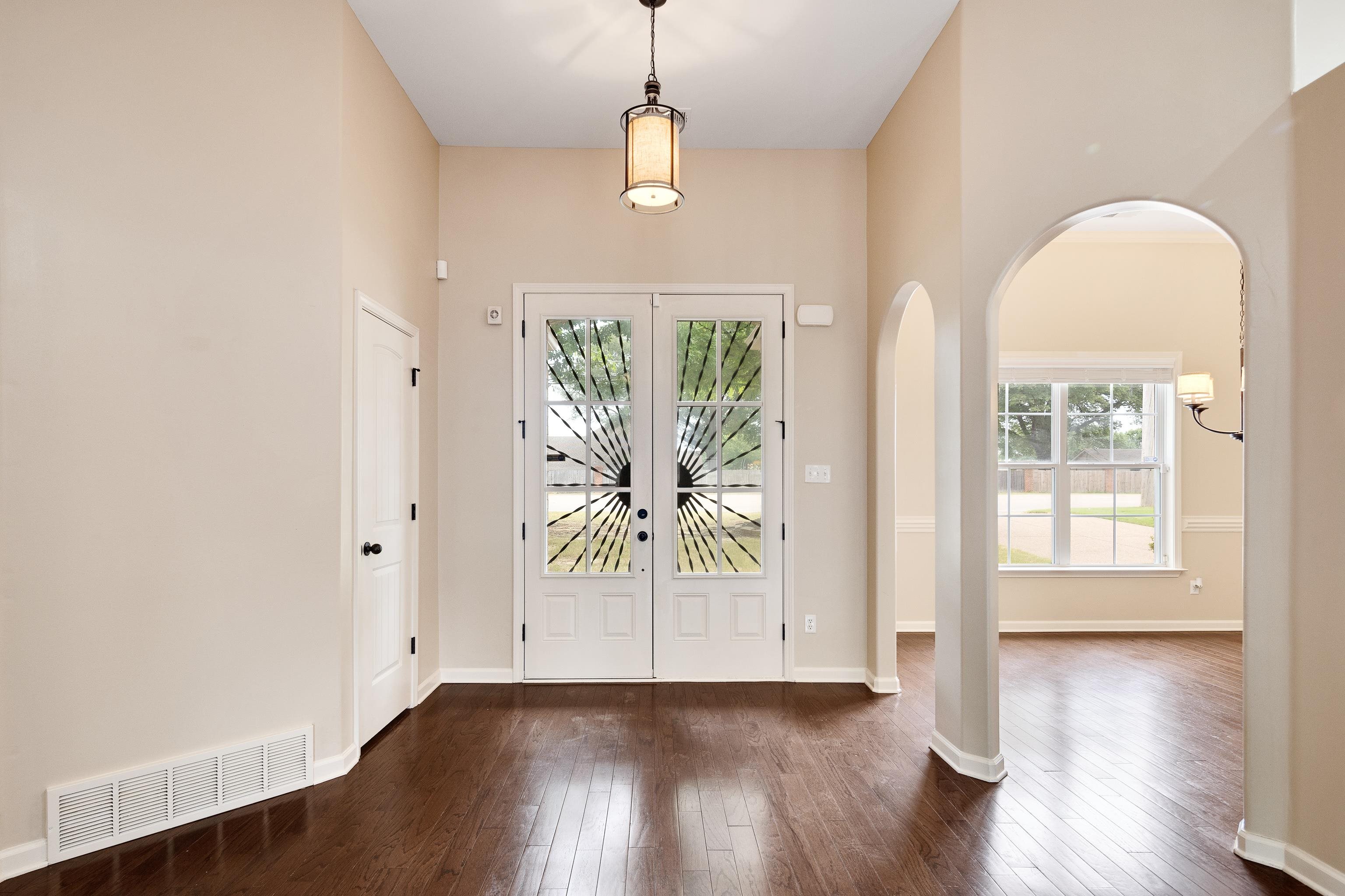 379 Shelton Road Collierville, TN 38017 - Photo 3 of 32 an empty room with wooden floor and windows