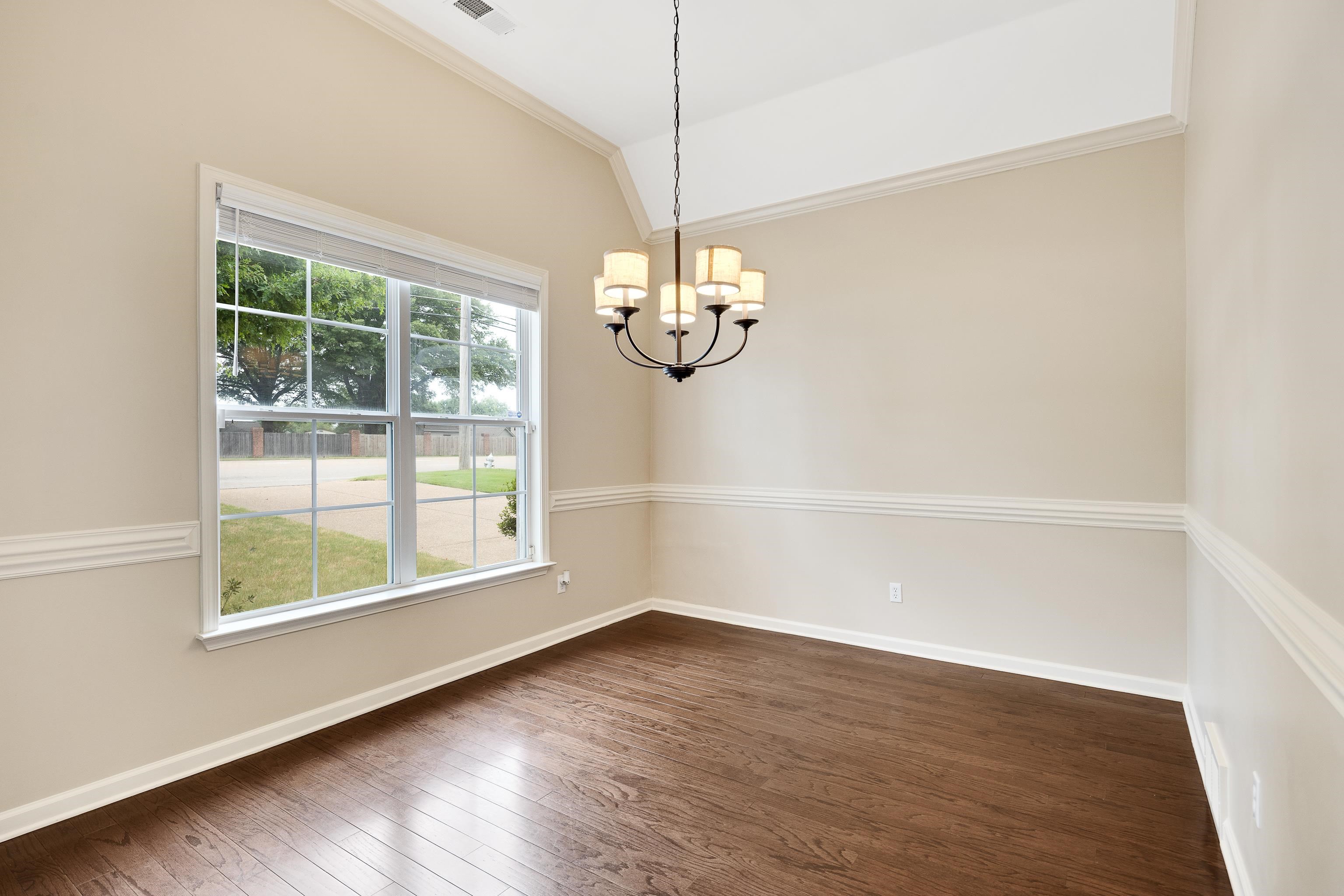 379 Shelton Road Collierville, TN 38017 - Photo 5 of 32 an empty room with wooden floor and windows