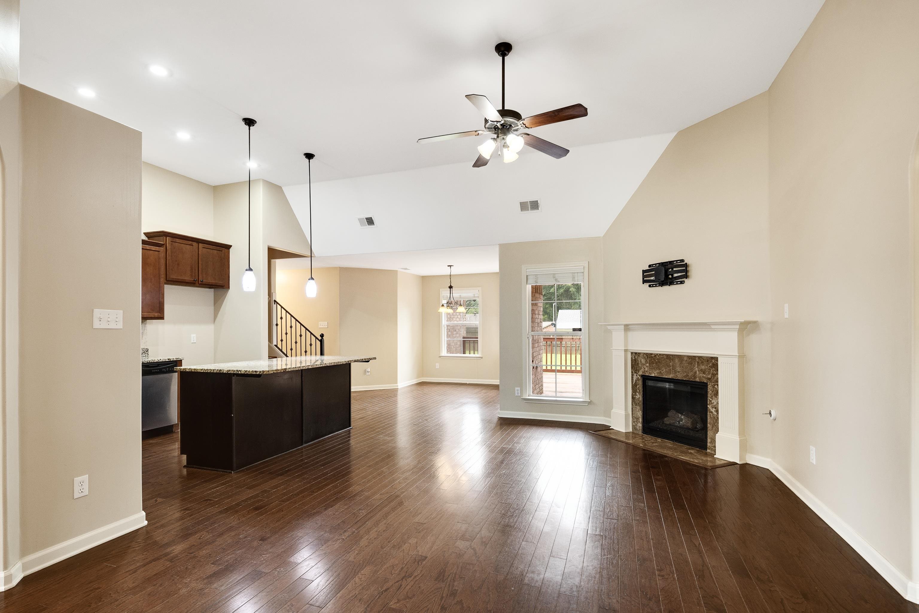 379 Shelton Road Collierville, TN 38017 - Photo 7 of 32 a view of a kitchen with a stove wooden cabinets and wooden floor