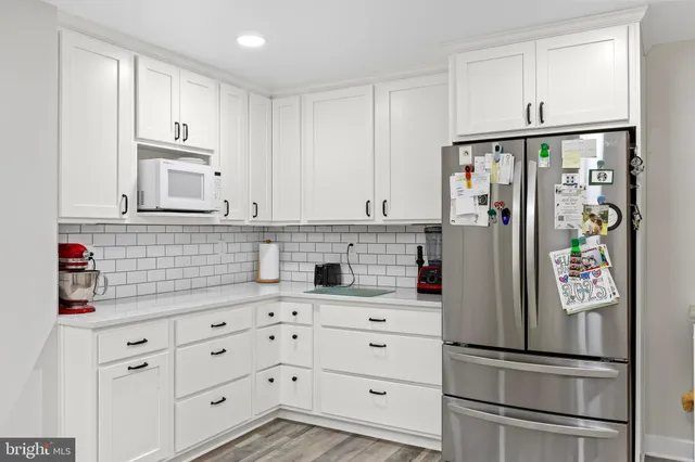 a living room with furniture windows and a flat screen tv