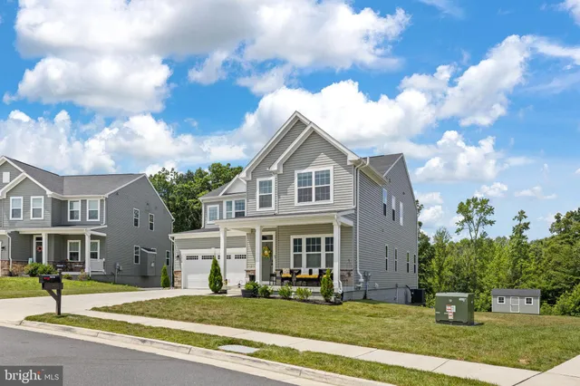 a kitchen with granite countertop a stove a sink and a microwave