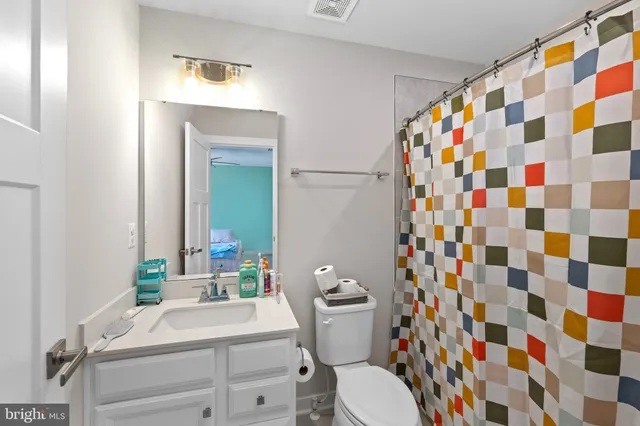 a bathroom with a sink mirror and toilet