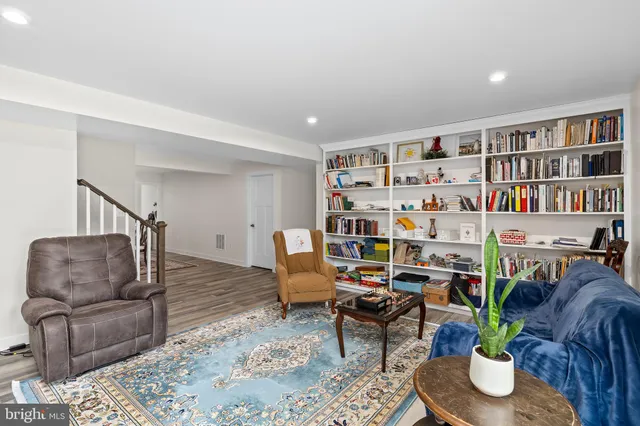 a front view of a house with a yard and potted plants