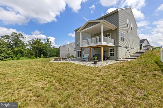 a view of a house with backyard porch and sitting area