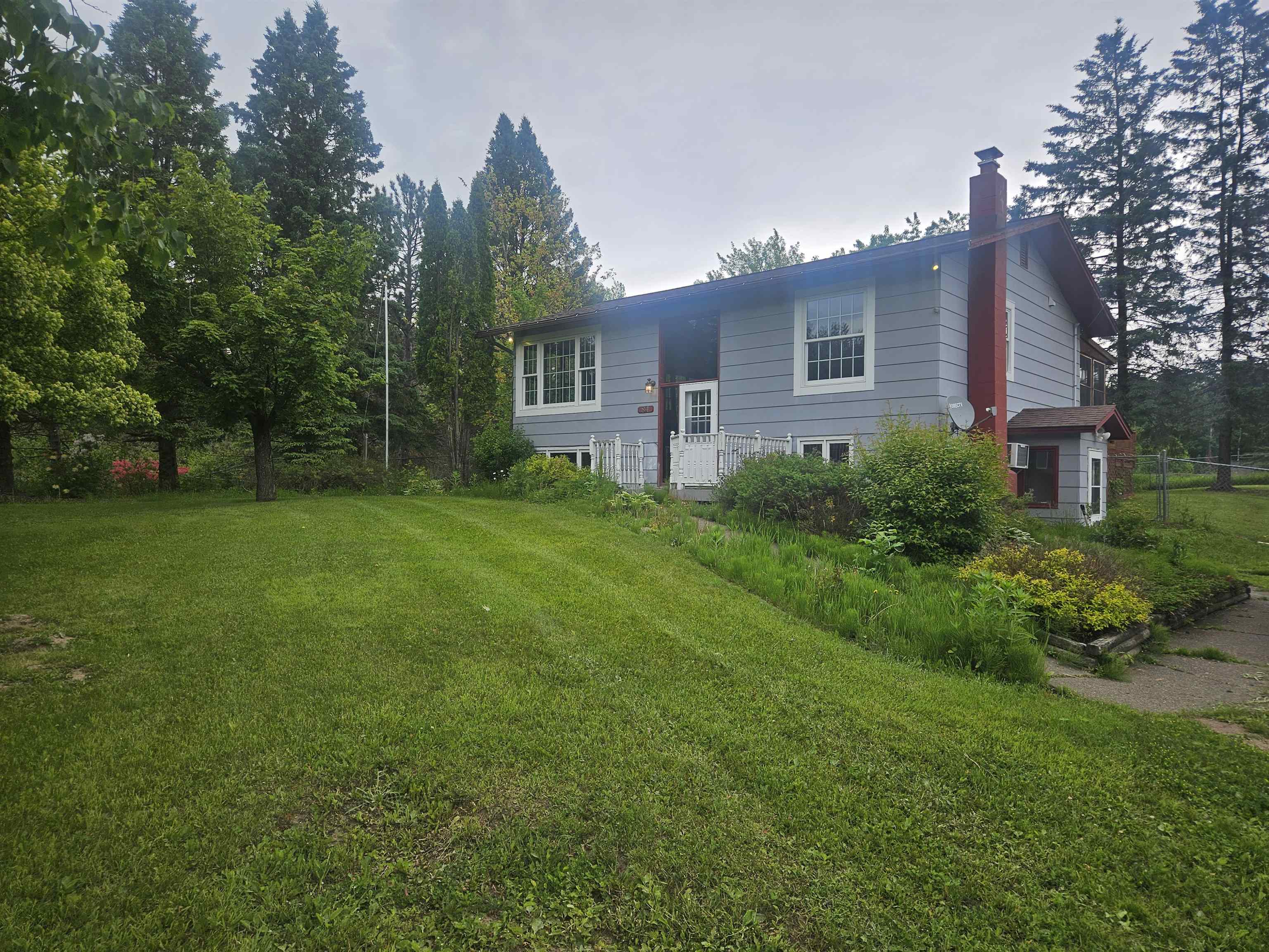 View of front of property featuring a front lawn and a chimney
