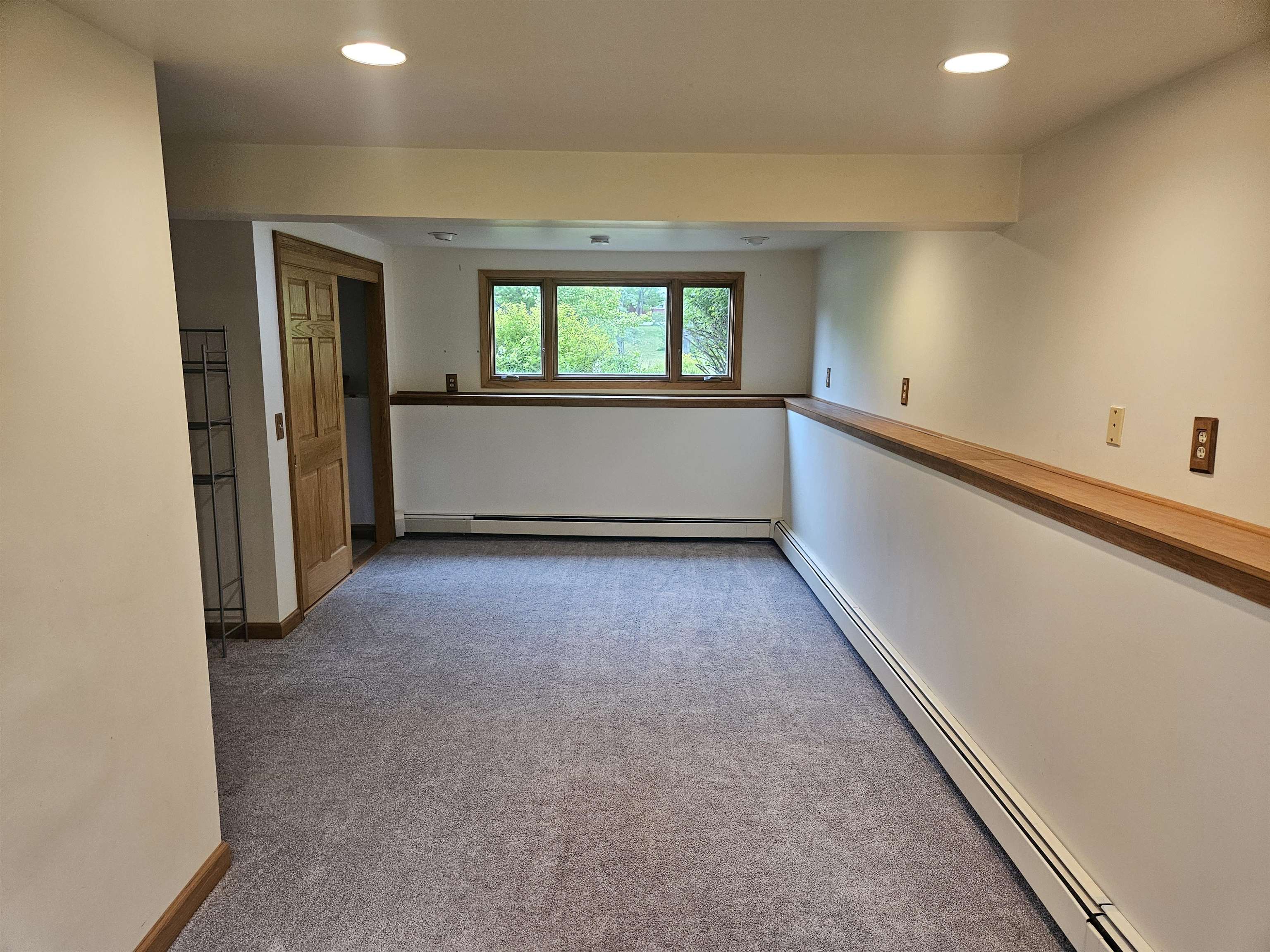 84 Erickson Road Esko, MN 55733 - Photo 12 of 16 Carpeted empty room with a baseboard heating unit and recessed lighting