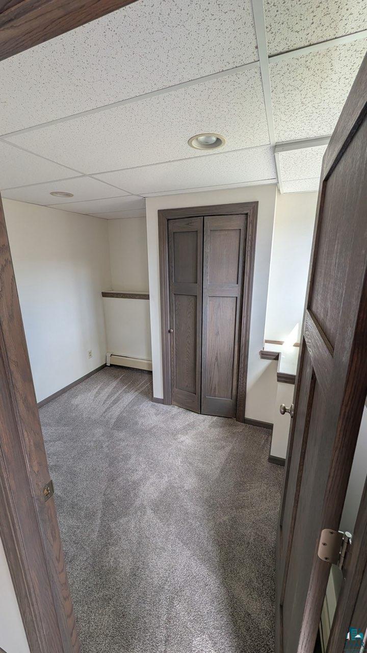 84 Erickson Road Esko, MN 55733 - Photo 14 of 16 Carpeted room featuring a drop ceiling with recessed lighting