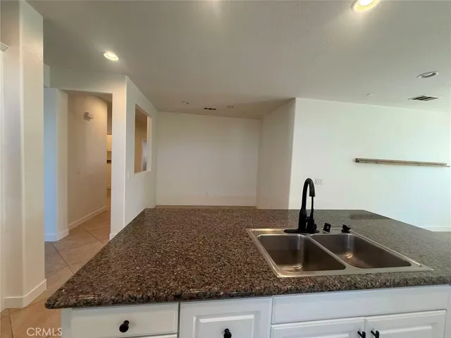 a kitchen with sink and refrigerator