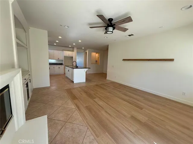 a view of a kitchen with a sink and a refrigerator
