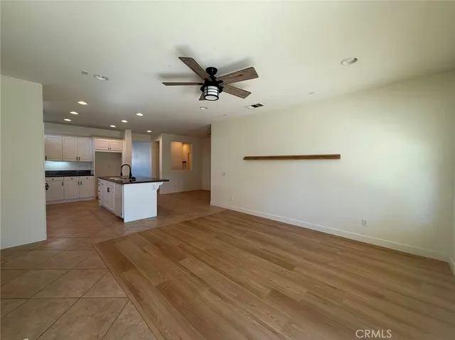 a view of a kitchen with a sink and a refrigerator