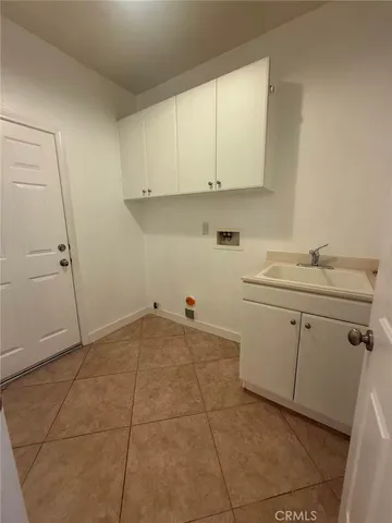 a view of a kitchen with white cabinets