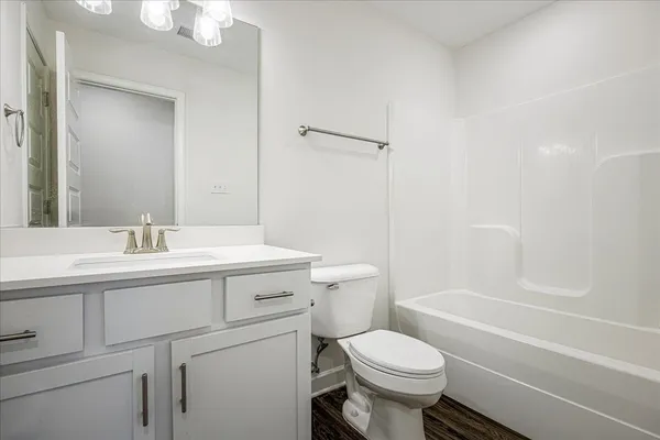 a bathroom with a sink toilet vanity and shower