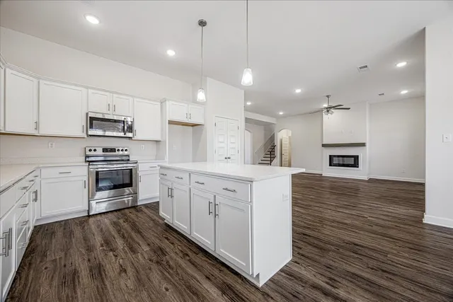 a kitchen with stainless steel appliances granite countertop a stove a sink and a refrigerator