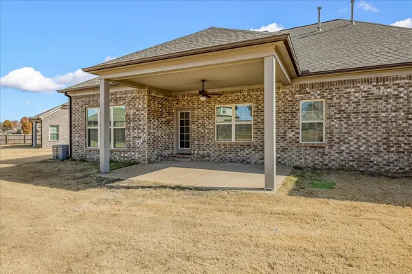 a view of a house with backyard and balcony
