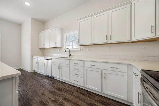 a kitchen with white cabinets and white appliances