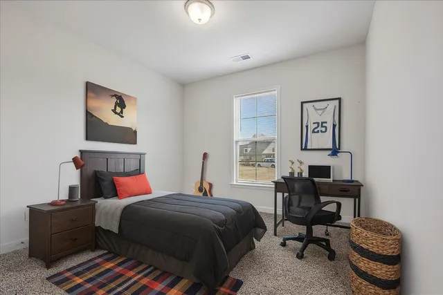 a bedroom with furniture and a window