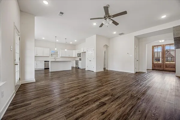 a kitchen with granite countertop white cabinets and white appliances