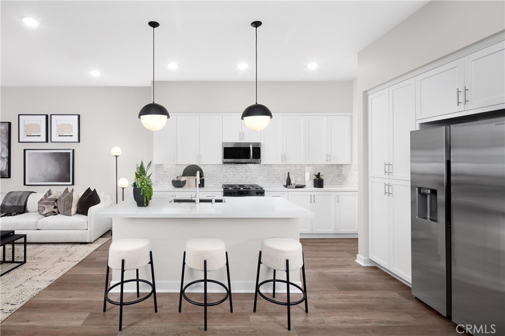 226 Roma Court Walnut, CA 91789 - Photo 8 of 16 a kitchen with kitchen island a dining table chairs stainless steel appliances and cabinets