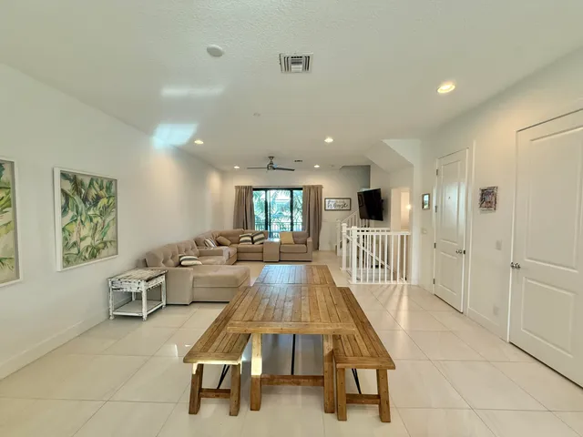 a large white kitchen with a large window