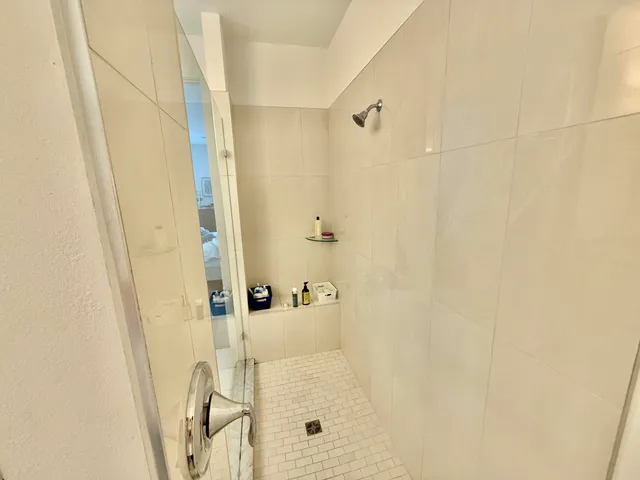 a en suite bathroom with a granite countertop sink and a mirror