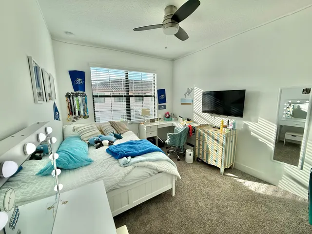 a bedroom with a bed and a chair