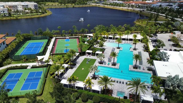 an aerial view of a house with a yard and lake view