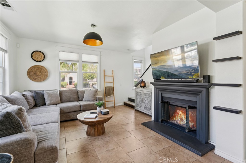4155 Windspring Street Corona, CA 92883 - Photo 7 of 38 a living room with furniture and a fireplace
