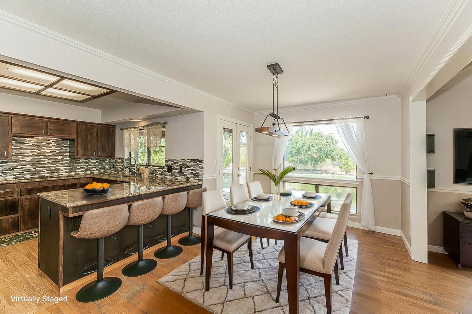41371 Butte Way Madera, CA 93636 - Photo 11 of 84 a view of a dining room with furniture window and wooden floor