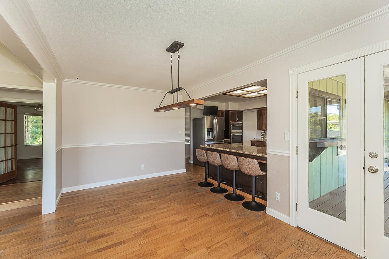 41371 Butte Way Madera, CA 93636 - Photo 13 of 84 a view of a livingroom with wooden floor and stairs