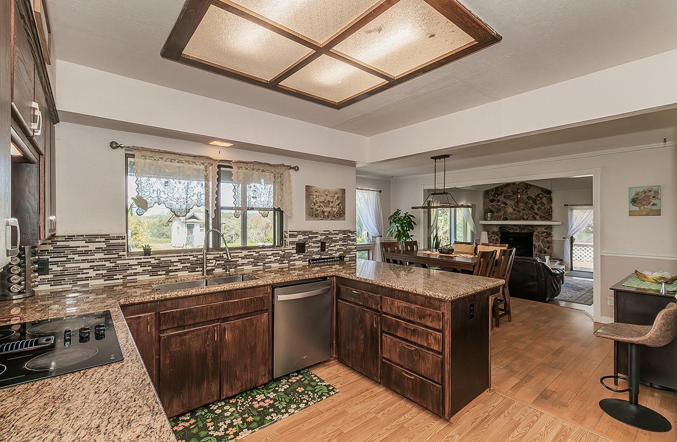 41371 Butte Way Madera, CA 93636 - Photo 16 of 84 a kitchen with lots of counter top space and living room