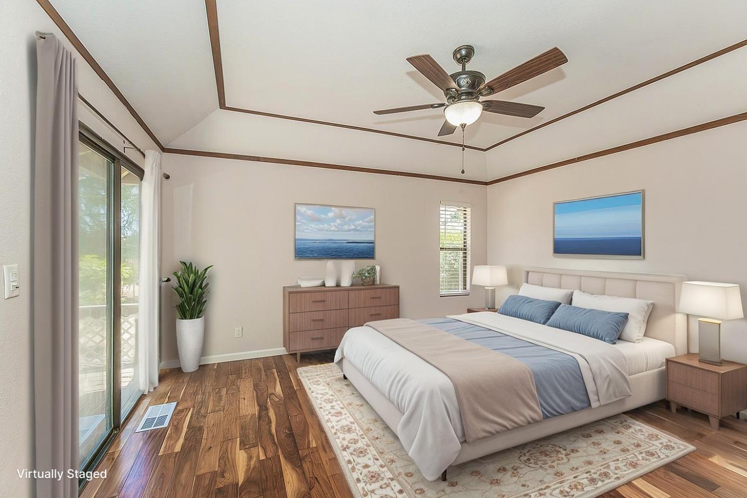 41371 Butte Way Madera, CA 93636 - Photo 19 of 84 a bedroom with a large bed and a chandelier