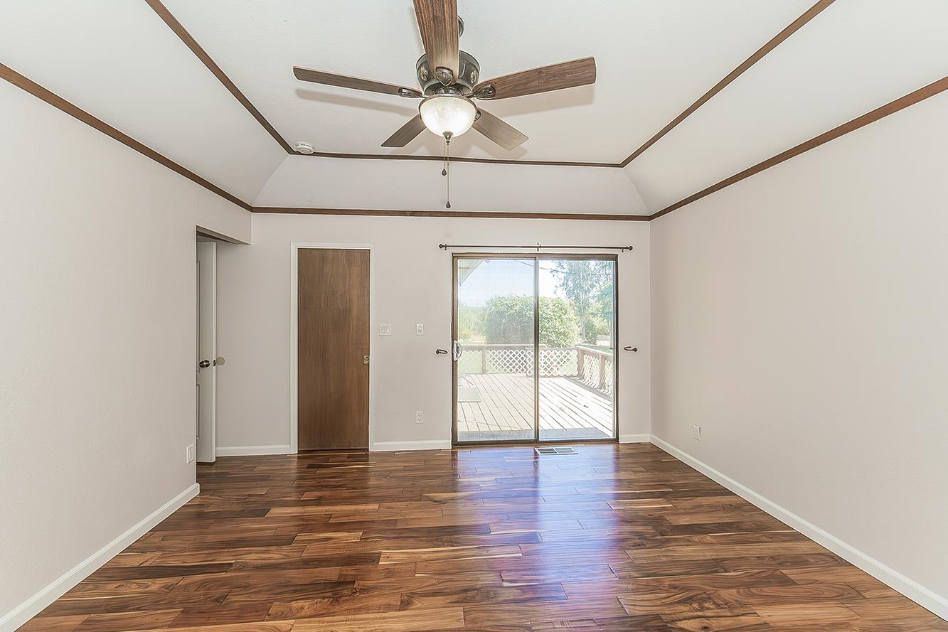 41371 Butte Way Madera, CA 93636 - Photo 22 of 84 a view of an empty room with wooden floor and a window