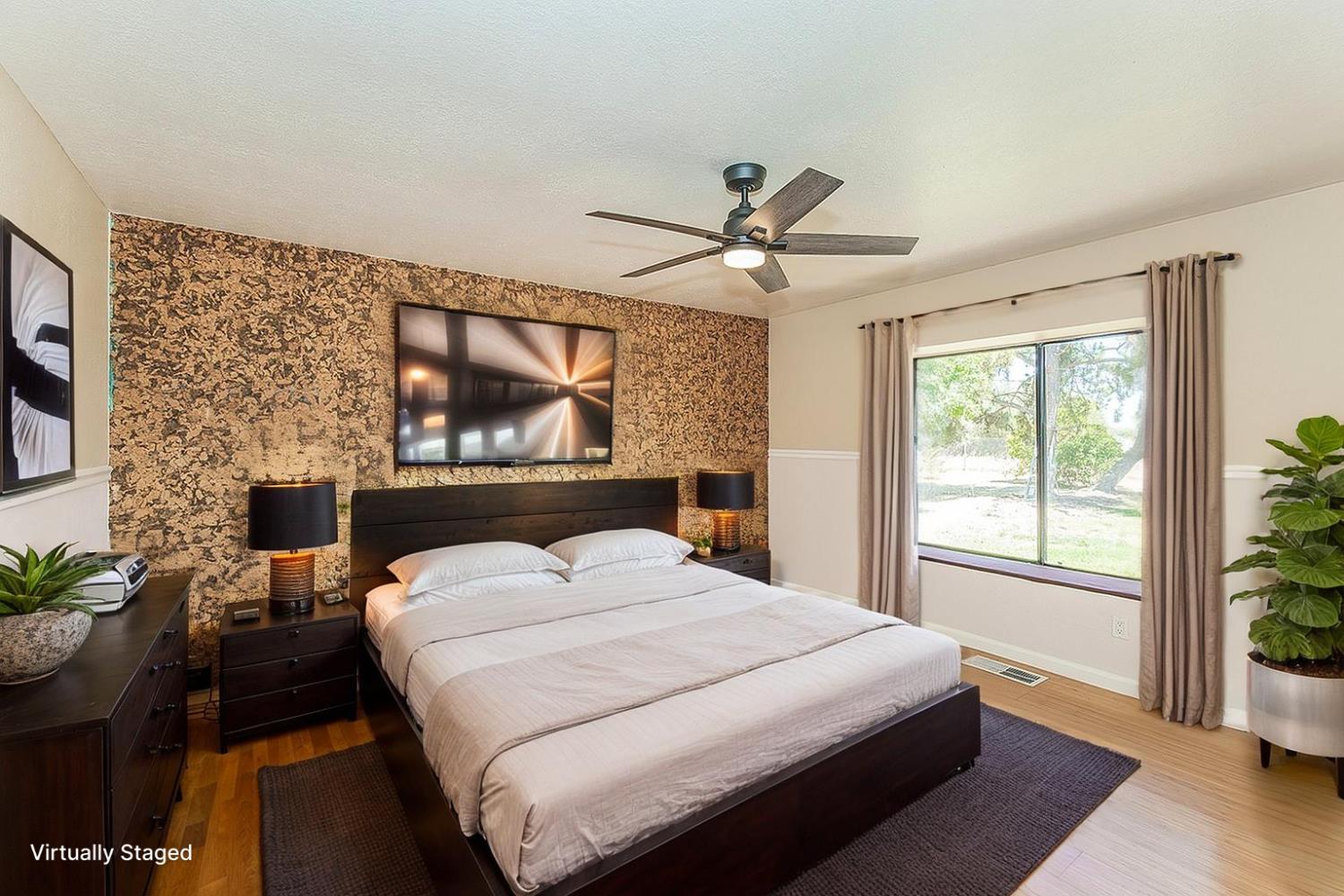 41371 Butte Way Madera, CA 93636 - Photo 27 of 84 a bedroom with a large bed and a large window