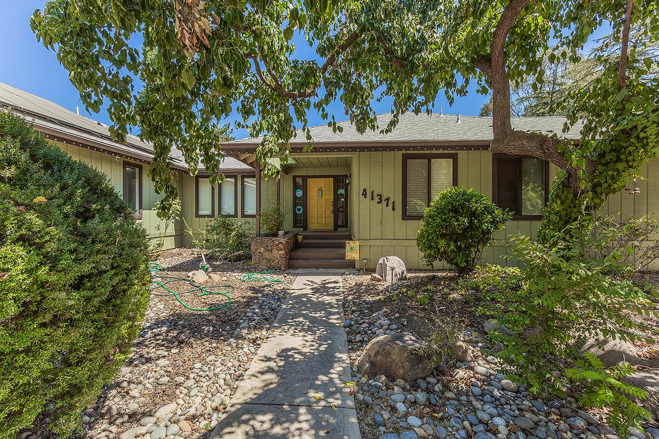 41371 Butte Way Madera, CA 93636 - Photo 3 of 84 a front view of a house with garden