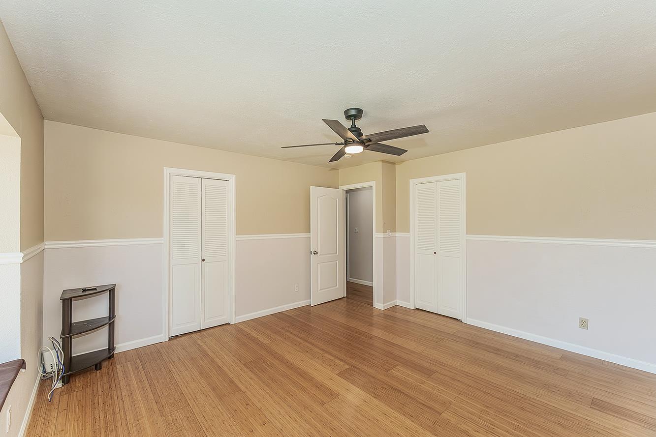 41371 Butte Way Madera, CA 93636 - Photo 31 of 84 a view of a livingroom with a wooden floor and a ceiling fan