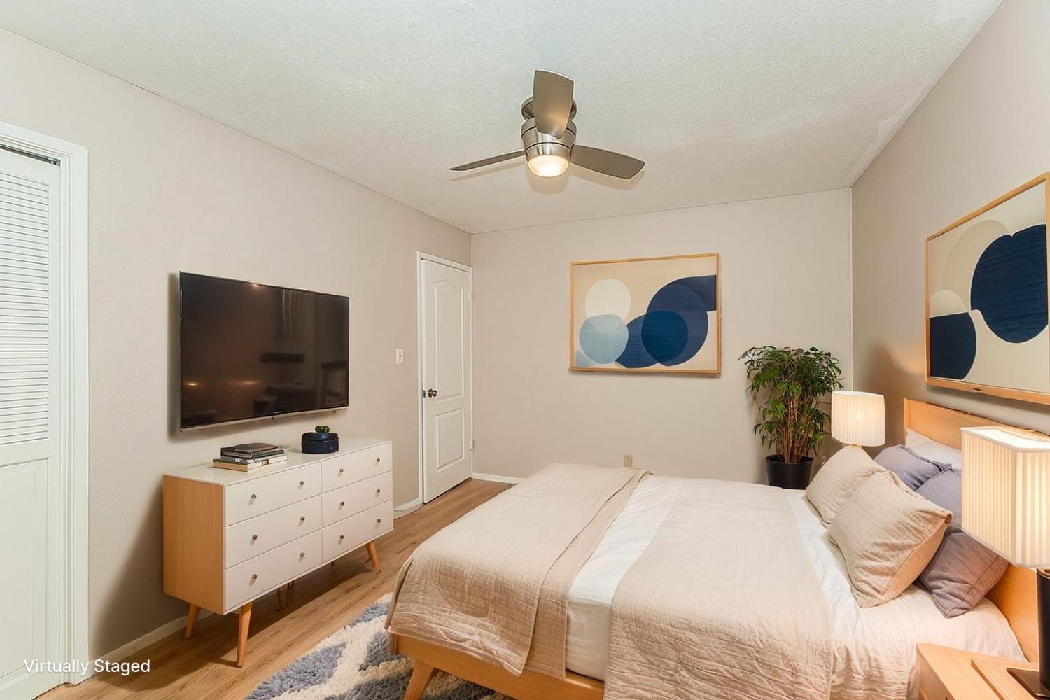 41371 Butte Way Madera, CA 93636 - Photo 32 of 84 a bedroom with a bed and a flat tv screen on dresser