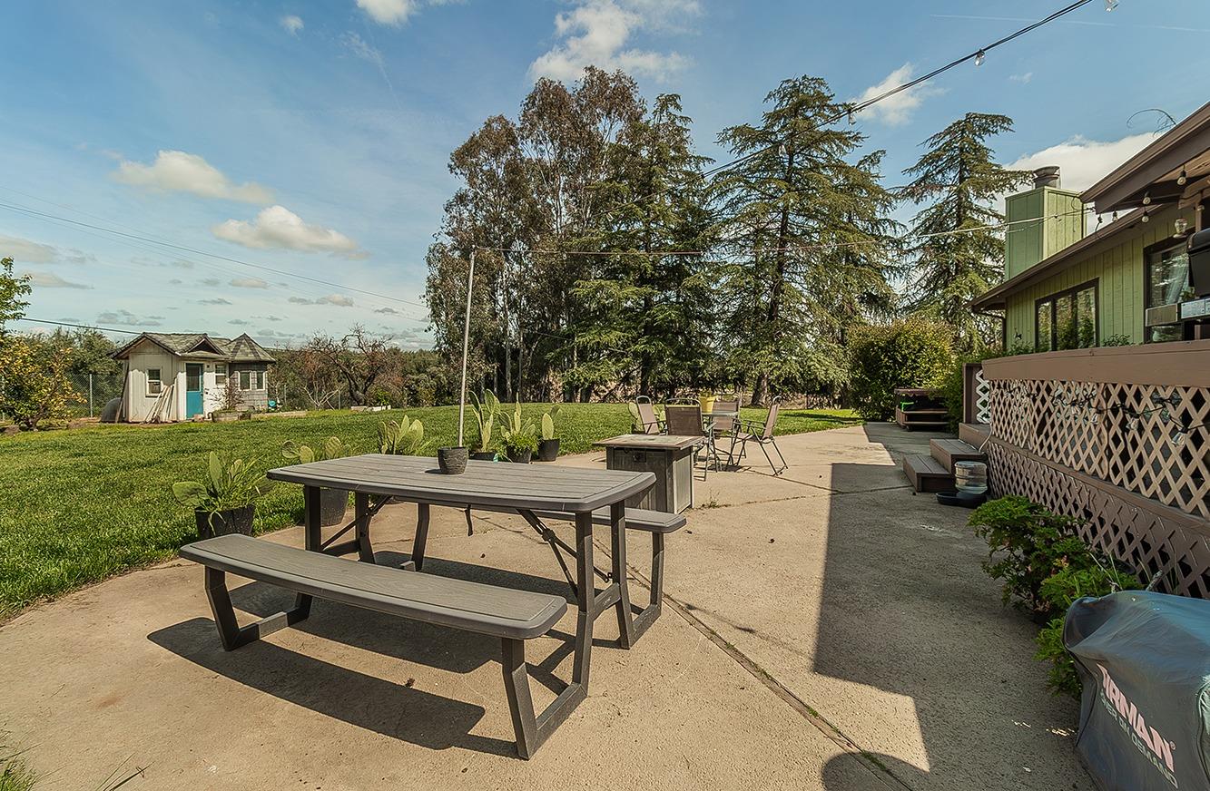 41371 Butte Way Madera, CA 93636 - Photo 42 of 84 a view of a patio with a table and chairs